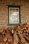 firewood by cottage window