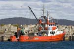 red fishing boat trawler in port at eden nsw