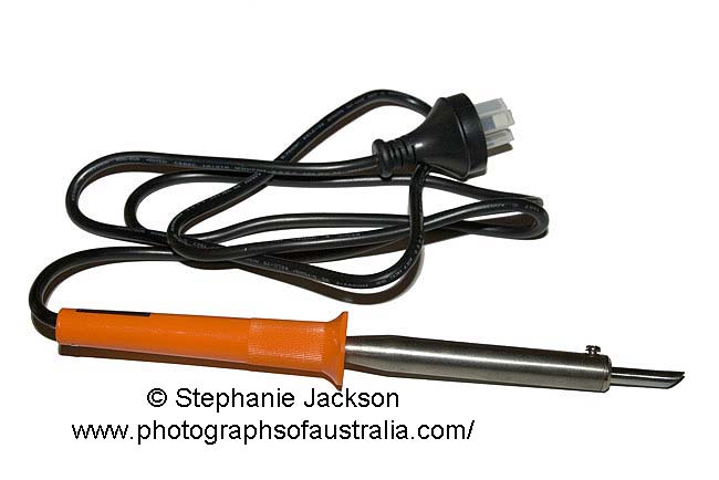 electric soldering iron on white background