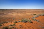 outback landscape of sand dunes and barren red plains in Queensland australia