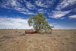 outback landscape with wrecked car
