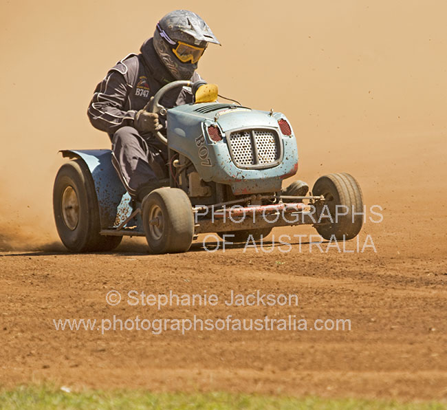 man competing in lawn mower race