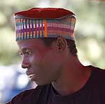 black african man wearing colourful hat